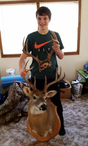 Sophomore Ryan Sprouse is holding the bucks he shot last year (bottom) and this year (top). Both deer are ten point bucks. -Photo Submitted