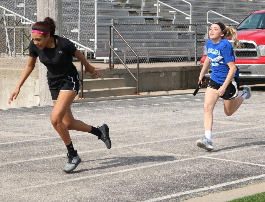 Freshman Rayni Simons passes the baton to freshman Ariaunna Johnson. The track team started practice during the first week of March.