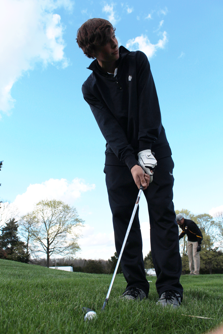 Sophomore Logan Davis gets ready to putt during a home match. The golf team played against Versailles and several other teams.