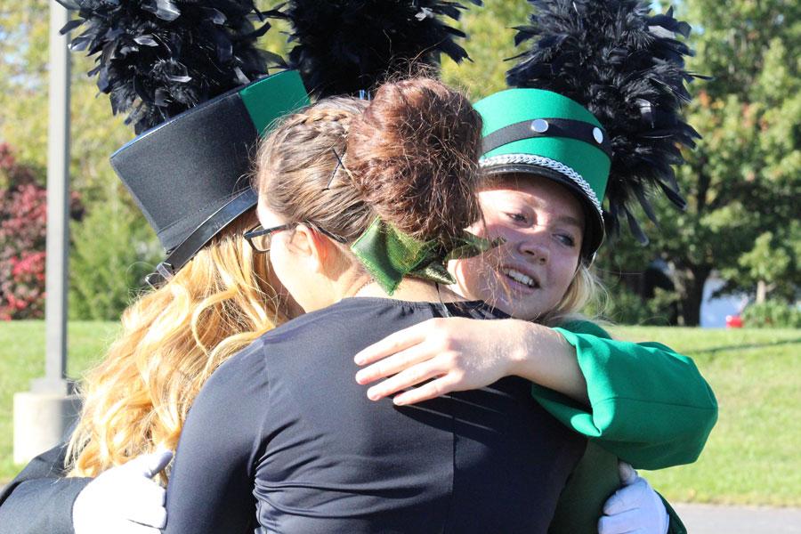 Senior Megan Brown hugs fellow senior band members after performing their last marching band show at Odessa. 