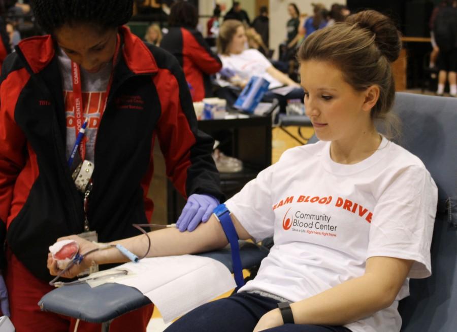 Senior Julie Franklin donates blood at the student-council sponsored drive on March 6. Ninety-seven people came to donate blood, 16 more than last year. There were 104 pints donated.  