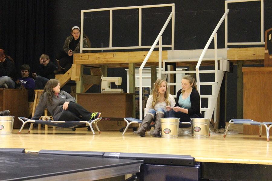 Annie+junior+Lydia+Schockmann%2C+reads+to+Molly%2C+junior+Madeline+McMillin+before+the+its+The+Hard+Knock+Life+number.+Annie+will+open+on+March+13.+Curtain+time+is+7+p.m.+on+Friday+and+Saturday+and+3+p.m.+on+Sunday.+