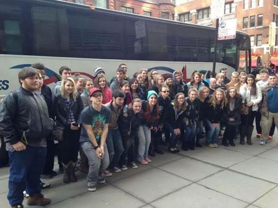 The+band+students+pose+outside+their+charter+bus+for+a+photo.+Students+were+then+able+to+walk+around+Chicago%E2%80%99s+famous+Magnificent+Mile+for+free+time+with+their+groups.