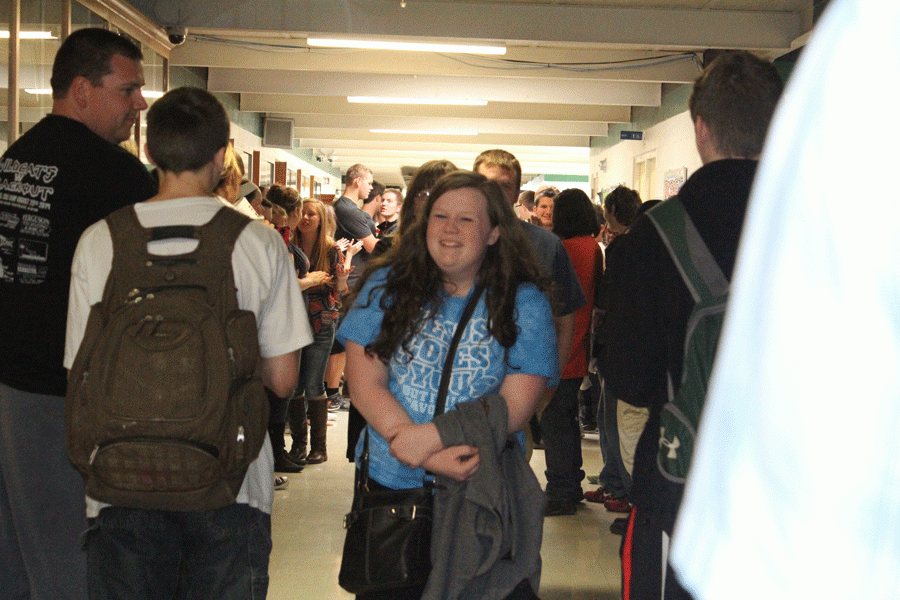 Freshman Caitlin Easter takes the walk down the hallway while being cheered on, as she is on her way to state speech contest.
