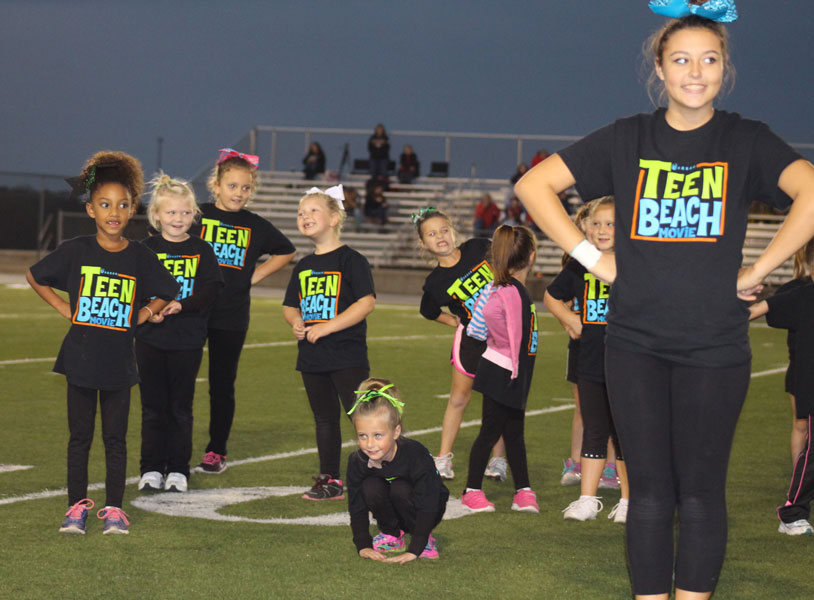 Freshman Chloe Lux leads girls in a cheer dance on October 5, 2015 during halftime of a JV football game.
