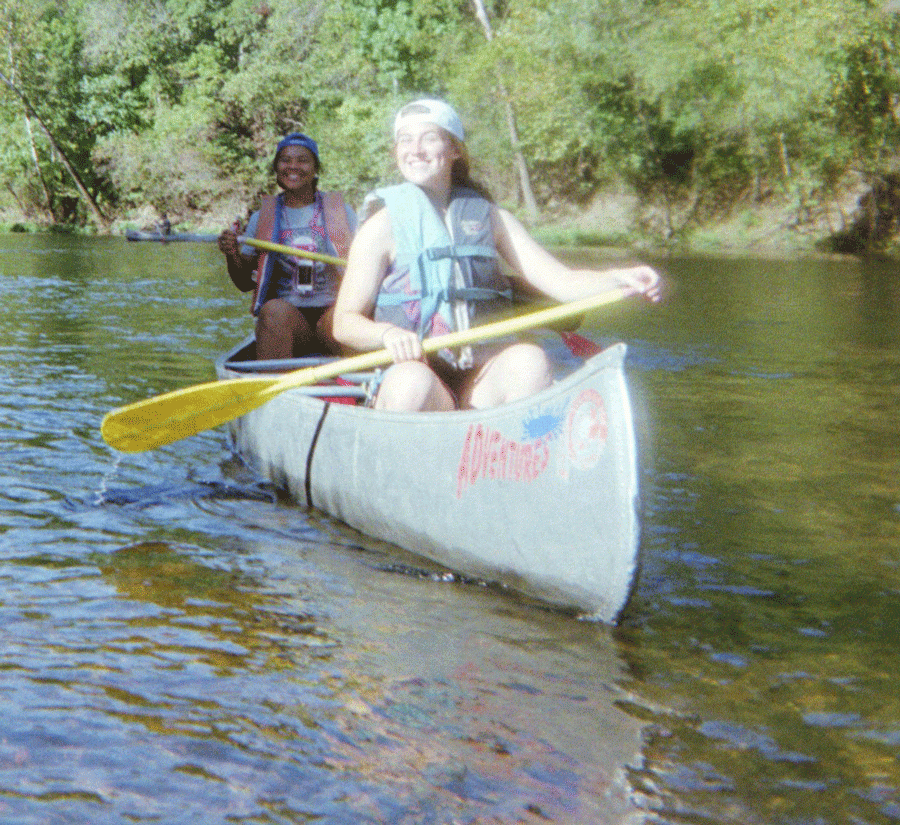 Seniors Keyona Davis and Kylie McRoberts smile as they float down the Niangua River. The science club has a float trip every year on a different river.