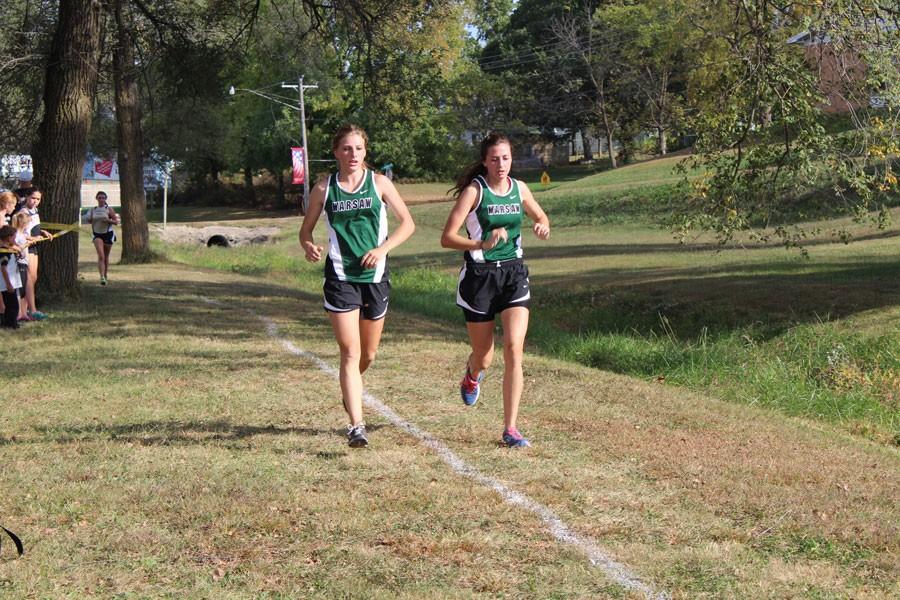 Sophomore Mikayla Andrews and junior Bailey Sharp run their course at the Stover meet. 