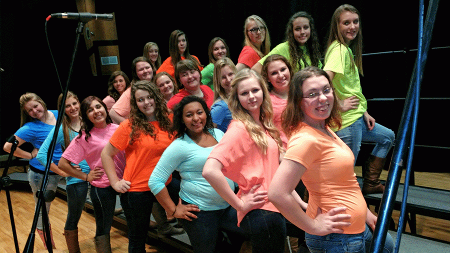  Lady vocalists freshmen Shelby Dunham,Savannah Goyette,Helena Givens,Caitlin Dudenhoeffer,Rylee pals, Suzy Cortright,Sophmore Emily Stantorf,Senior Sarah Easter,Senior lydia shockman,Senior Mary Porter,Sophmore Nadine Rider,junioe Johna Newman,junior Haleigh Kennedy ,sophomore  Makayla Andrews,sophmore Naomi Meyers,Haylee Pals,senior Raniece Dewitt,senior Cassie pittman, and Senior Jazmine Holbert stand on stage with their hips cocked.This group performed “These Boots are made for walking” at showstoppers.