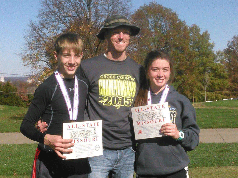 Sophomore Dallas Larsen, coach Ehren Banfield, and junior Ashlee Kuykendall celebrate after the state cross country meet in Jefferson City. Kuykendall placed  22nd and Larsen placed 25th. Photo submitted.