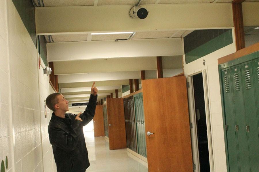 Sophomore Ryan Burks points at new Speakers in the senior hallway. The speakers were added to the school over Christmas Break. 