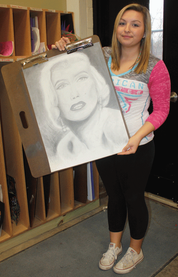 Senior Megan Barnett shows off her drawing of Marilyn Monroe. Barnett plans on going to college to become a teacher. 
