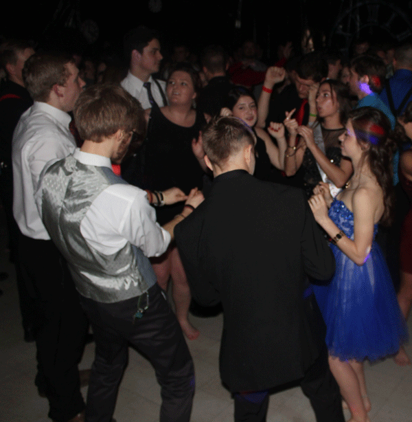 Juniors Josef Black, Kaci Cooner, Erica Flores, Bailey Sharp, Ashlee Kuykendall, sophomore Dallas Larsen, senior Carter Phillips, and junior Michael Pierce form a dance circle. Students also formed a mosh pit for the more hardcore songs later that evening.

