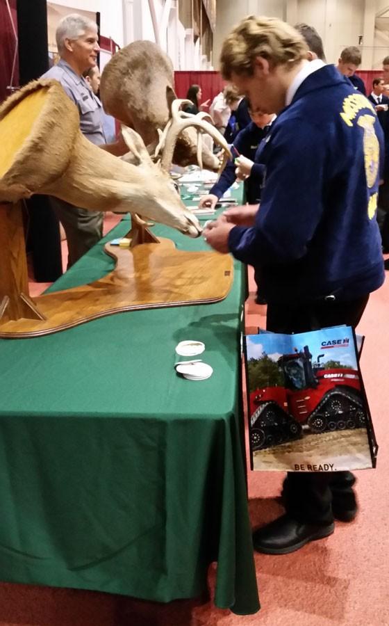Senior Derek Wright checks out the Missouri Conservation Department booth at the FFA State Convention career show.  This was Wrights last year attending State Convention as a student.