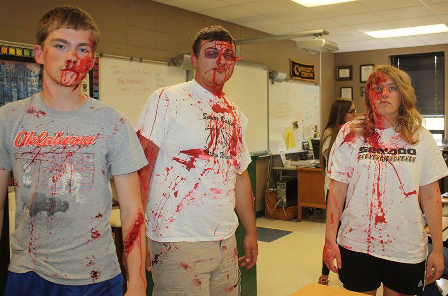Sophomore David Derks and seniors Austin McCall and Madison Lane pose for a picture with their gory makeup.  McCall and Derks died in the staged car accident and Lane was lifeflighted.
