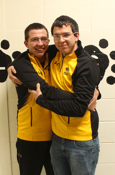 Seniors Mason and Ryan Flippin embrace each other in thie senior hallway. Mason’s return to school after the accident was special for both him and his twin brother. 
