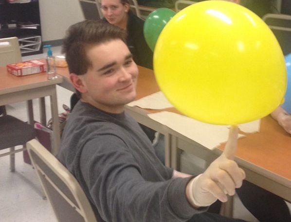 Senior Andrew Savage  entertains himself with a balloon in his Health Occupations class at CTC. The class practices shaving facial hair with the balloons.