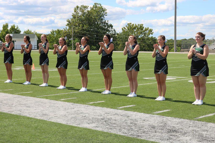 Freshman Madie Breshears, sophomore Kayla Boucher, sophomore Shelby Dunnam, senior Johna Newman, junior Emily stantorf, sophomore Chloe Lux, sophomore Ciara Cooper, junior Briar Heavener, and junior Madi Rozzel perform a cheer at the Homecoming assembly. The cheerleading squad also performed a dance routine at the assembly as well. Photo by Alexis Smith. 
