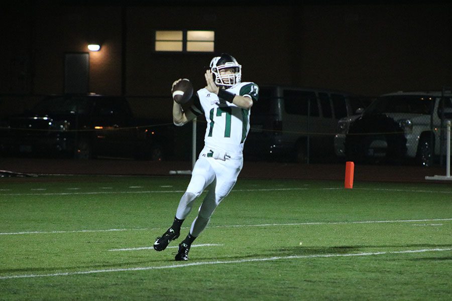 Sophomore quarterback Matt Luebbert throws the ball to a teammate during a game against Versailles. The team lost to the Tigers 35-14.
