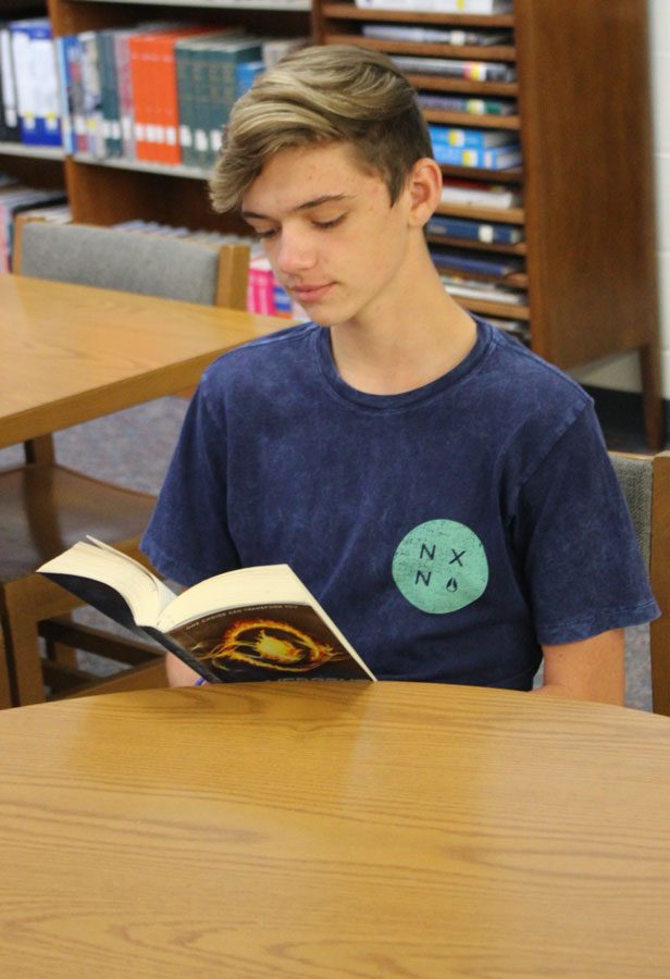 Sophomore Riley Bagley reads during advisory time. 
The library was reorganized this last summer by genre to help ensure that students can find what they like to read. 
