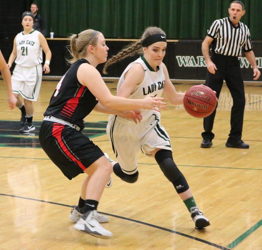 Junior Hannah Chapman dribbles down the court in a game against Conway during the Warsaw Tournament. The Lady Cats defeated the Lady Bears 64-50  as their second win of the season.