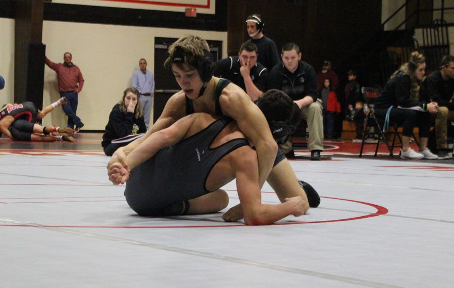 Junior Dallas Larsen wrestlers against an opponent at the Butler Tournament on Jan. 7. Larsen recently defeated the second ranked wrestler in the state. 