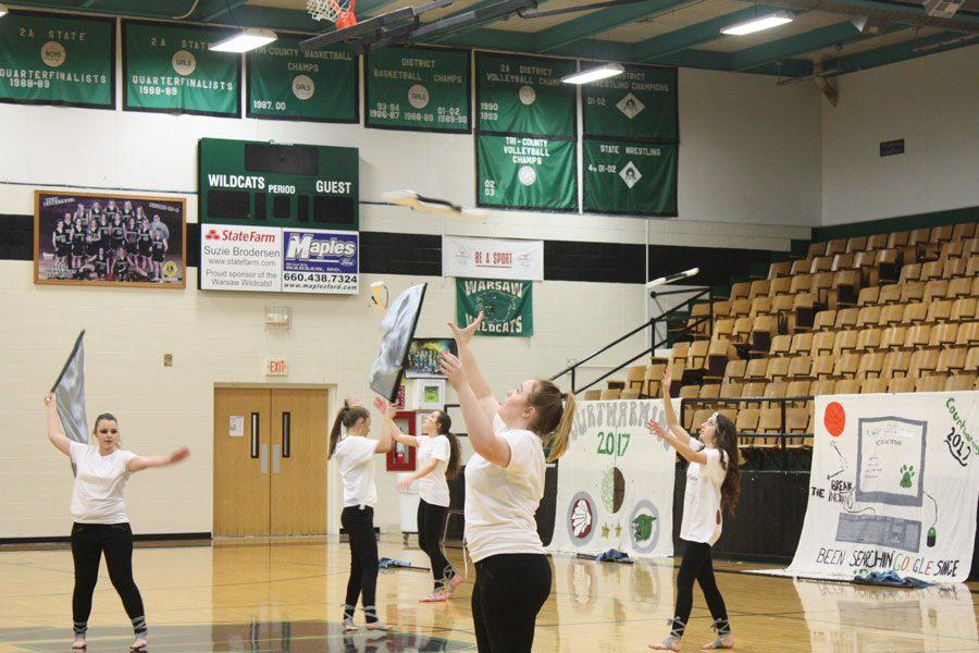 Senior Nichole Payne, sophomores
Suzy Cortright, Rylee Pals,
Taylor Bunch, and junior Kyra Kleihauer
perform with the color guard
during the Courtwarming assembly.
This was the first year for indoor color
guard performances.