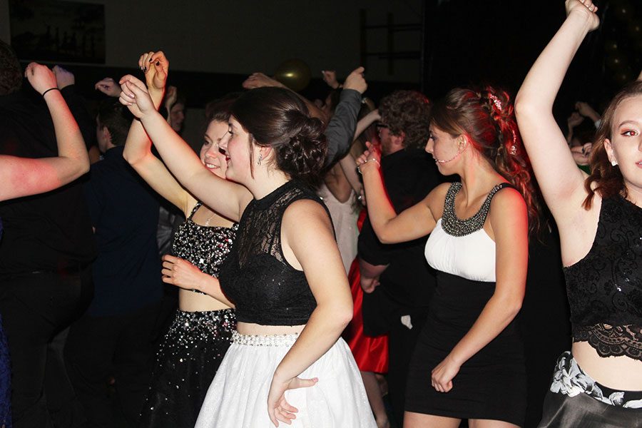 Seniors Erica Flores, Ashlee Kuykendall and Ashlyn Yoder dance at the Echoes Ball. Flores was a queen candidate. 
