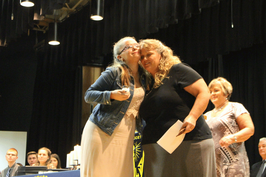 junior Makenzie Hensley is inducted into NHS by South School kindergarten teacher Roxanna Eckhoff. Hensley is known for being a great student with a great attitude. 