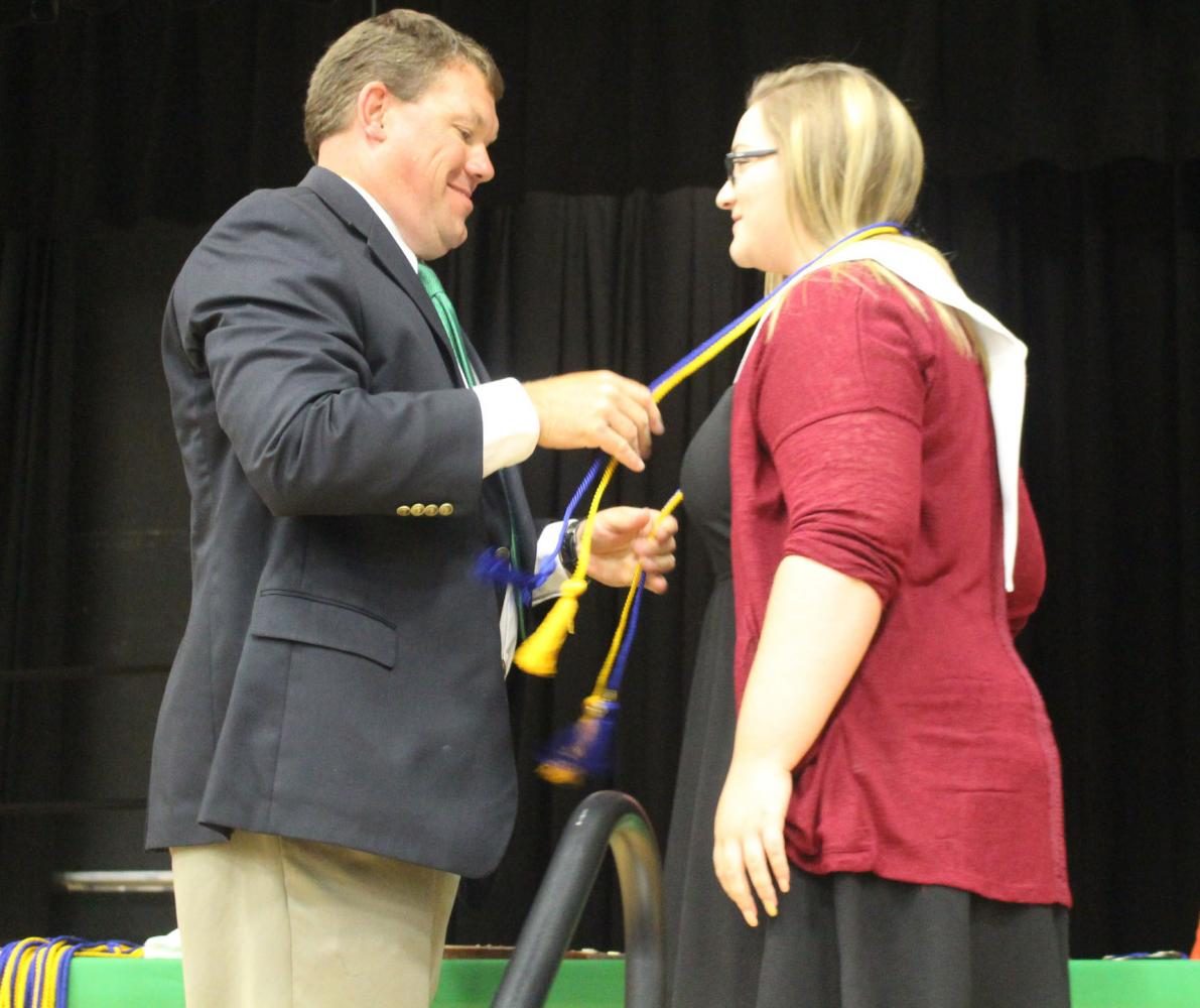 Senior Maddie Freeman is presented her National Honor Society cords at senior awards on Sunday, May 14. Freeman removes all noise and distraction when going to study, even though she naturally has an easy time with academics.