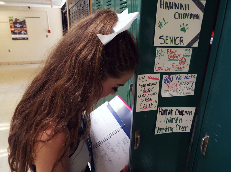 Senior Hannah Chapman reluctantly looks over her plans on her first day back to school. Chapman is involved in volleyball, cross country, cheerleading, color guard, and is student body president. Photo by Kylee Creach.