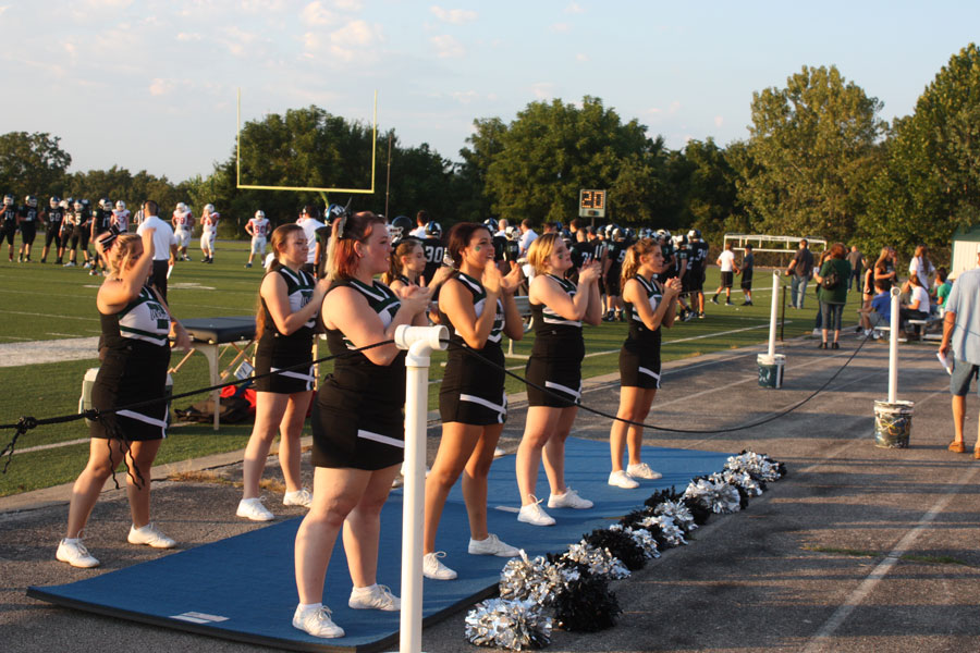 The WHS cheer squad applauds the  Wildcat football team during their home game against Clinton. Cheer captain Chloe Lux has been on the team for three years and plans to continue throughout her senior year. 