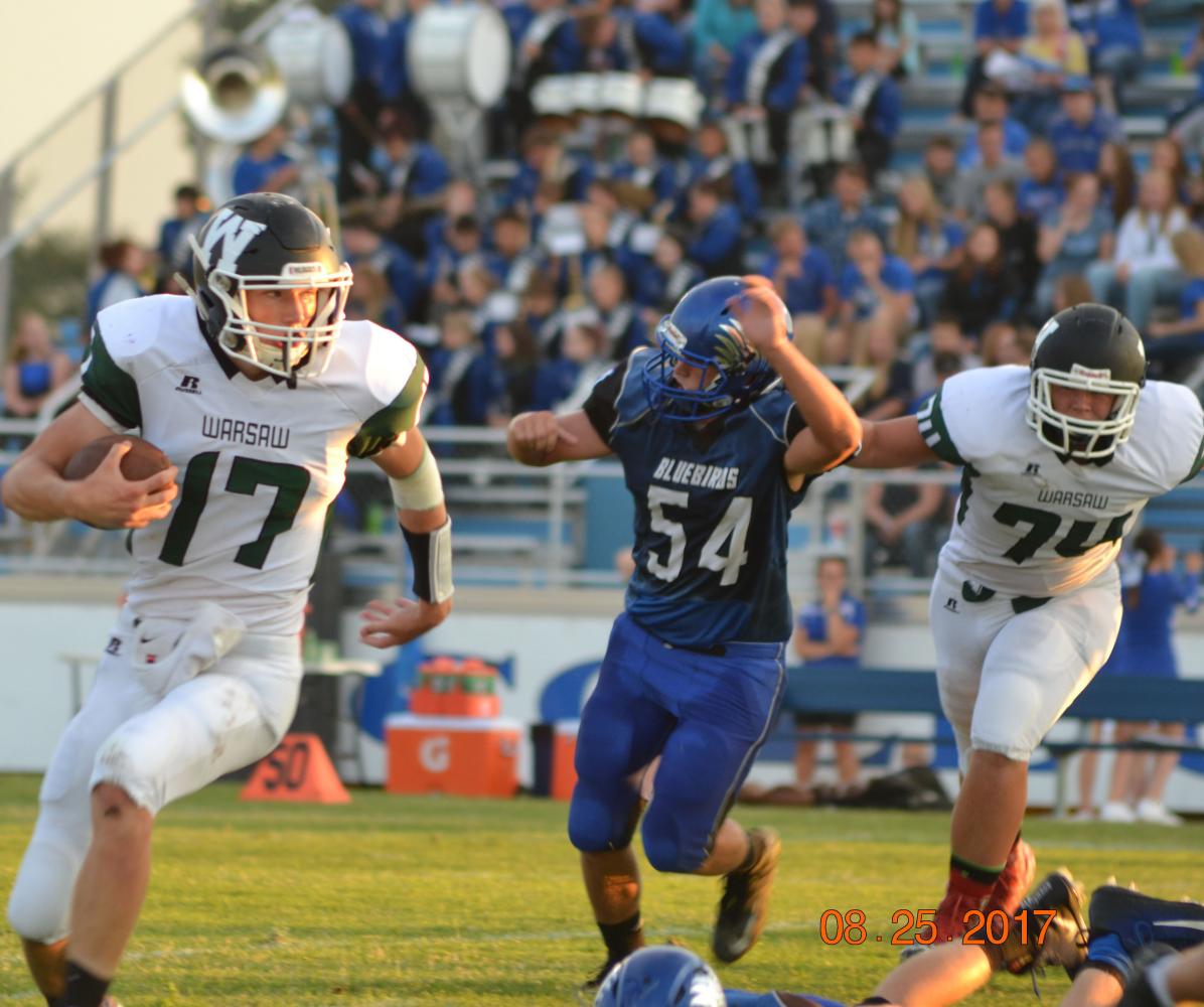 Junior quarterback Matt Luebbert runs the ball down the field. The football team beat Cole Camp 28-22. Photo by Kya Schepker.