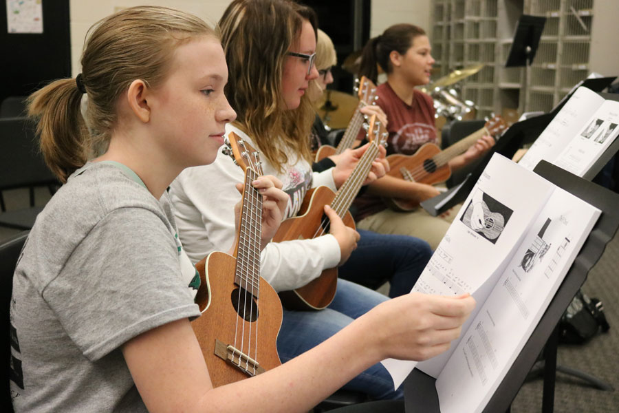 Sophomores Samantha Townley, Autumn Bauer and seniors Molly Baumhoff and Zoe Eledge strummed their first chords on the ukulele during practice with band teacher Brandi Holt. This was Holt’s first year teaching ukulele at Warsaw high.