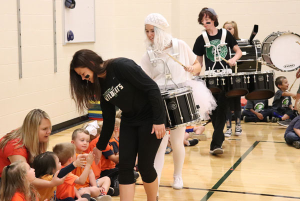 Senior drum major Zoe Eledge and the drum line goes through and high fives the children. All the organizations went through and high fives the children at the beginning and the end of the assembly.