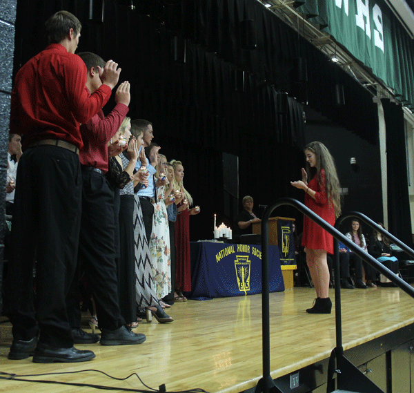 Senior Hannah Chapman leads the new members in the NHS pledge. A total of 20 new members were inducted on Oct 4. 
