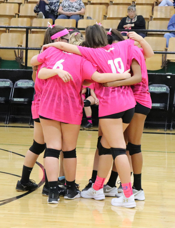 JV+starters+pray+in+a+huddle+before+the+game+against+Osage+on+Oct.12.+Praying+before+each+game+is+one+of+the+many+traditions+the+volleyball+team+has.+