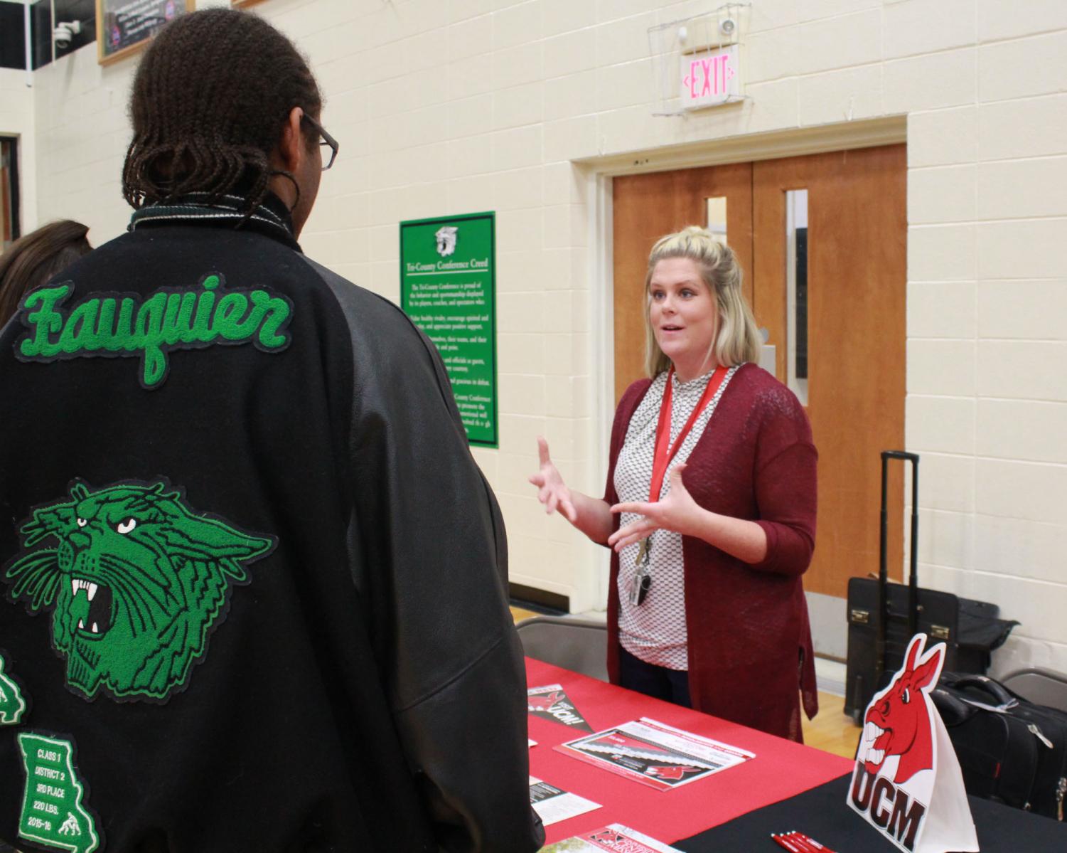 Senior Nate Fauqier looking at UCM college. UCM representative helps students with questions they have.