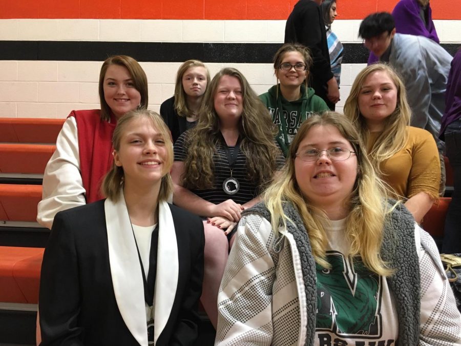 Speech club members (back 
row left to right)  sophomores Samantha Townley and Aubri Umlauf, seniors Madison Rozzel and Caitlin Easter, junior Ren Rozzel, freshman Lacey Andrews and junior Electa Good wait to perform their pieces during the Knob Noster speech competition.