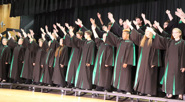 The concert choir singing and dancing to one of the group songs. One of the groups songs was dream on. 