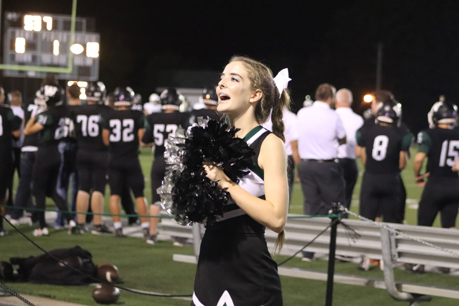 Senior Hannah Chapman cheers at a home football game against Blair Oaks. Chapman participated in Cross country. volleyball, cheerleading and colorguard during the fall season. “Dual sporting or triple sporting requires a lot of help from a lot of people. I wouldn’t have been able to do it without my parents, coaches and my teammates,” Chapman said.