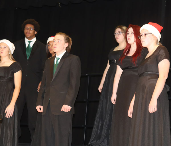 Sophomore Aubrie McRoberts, senior Nate Fauquier, sophomore Aiyana Chenault, juniors Chance Thirstrup, Allison Thomas and sophomores Alyssa Gemes and Jessica Dwyer sing in the winter concert. The winter concert featured concert band, jazz band and all choirs.  