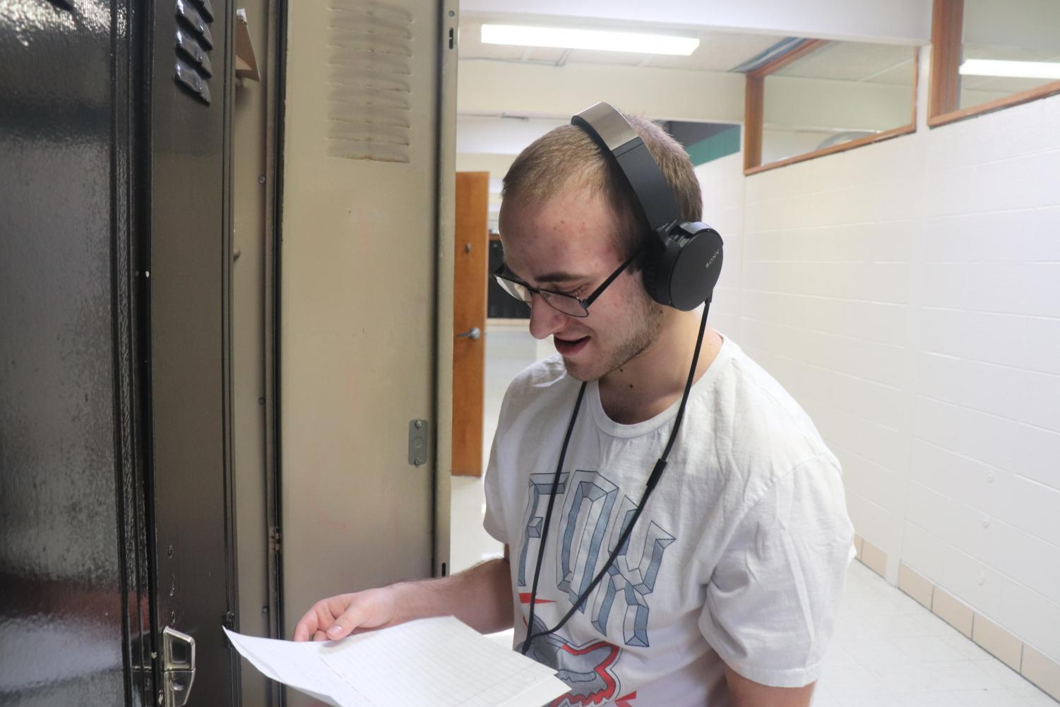 Senior Eric Meldrum gets rid of leftover math homework and listens to Tech N9ne. Meldrum is usually never seen without his headphones. “I listen to music twenty-four seven.” He said.