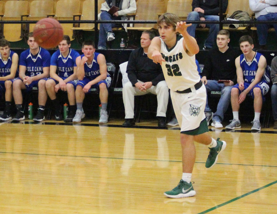 Keegan Glenn passes the ball to teammate. Playing on their home court, the boys played against Cole Camp.