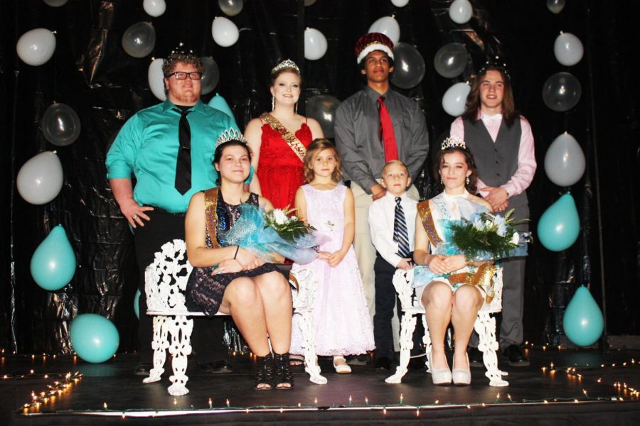 Senior king and queen Logan Neth and  Zoe Eledge and junior prince and princess, Chance Thirstrup and Autumn Long celebrate in the spotlight as Echoes Ball royalty. Graduates Makayla Mais and Wesley Carr, with the help of flower girl Addison Young and crown bearer Connor Roberts, awarded the royalty. Photo submitted