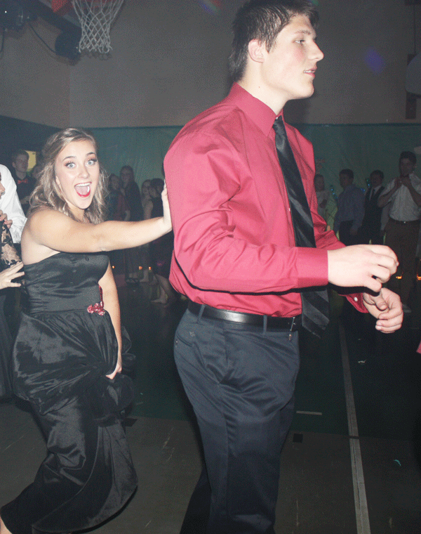 Junior Jacob Lubbert and sophomore Kiersten Grobe dance in a conga line. The dance was the only semi-formal dance for the year.