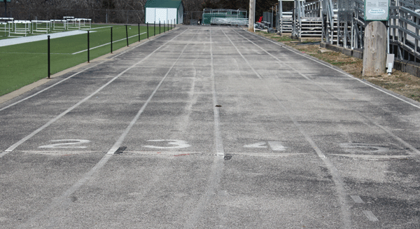 The current track situation for athletes. There is cracks, faded paint and not the correct amount of lanes.
