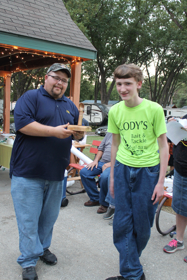 FFA Advisor Stan Adler awards the golden scoop to sophomore James Baumli for the winning ice cream at the Sept. 18