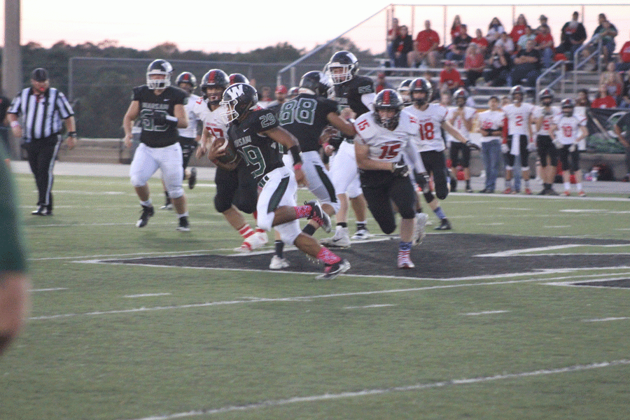 Senior Kieon Davis gains some yards against the El Dorado Bulldogs on Oct. 5. The Cats fell to the Dogs.