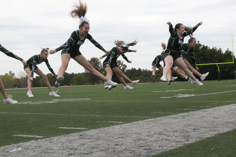 Junior+Alexus+Brown+goes+up+for+a+toe+touch+during+the+Homecoming+Assembly+in+September.+The+squads+competition+routine+qualified+for+the+state+competition+on+Dec.+1.+