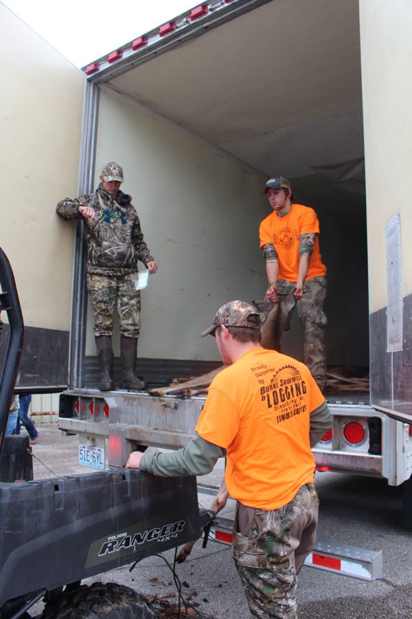 Sophomore Zachary Sharp and seniors Zack Nelson  and Dalton Nickles load a deer into the truck. All three students were volunteering on the handicap hunt during the weekend.  Photo by Lica Rosa